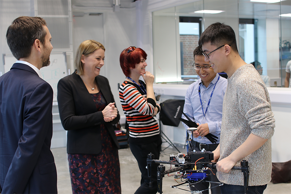 Aviation Minister, Baroness Sugg meets PhD students working on drone technology at the Aerial Robotics Lab at Imperial College, London.