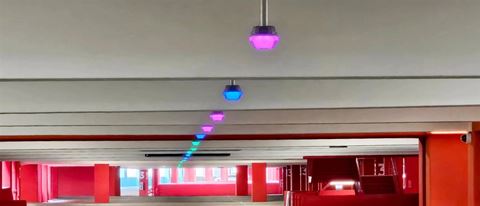 Colour coded lighting displays parking availability status within the garages.